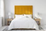 The Aries Headboard in mustard yellow in a bright modern bedroom