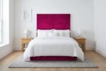 The Iris Headboard in magenta in a bright modern bedroom