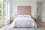 The Picasso Headboard in blush pink in a bright modern bedroom
