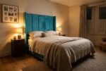 The Triumph Headboard in teal in a warm evening bedroom